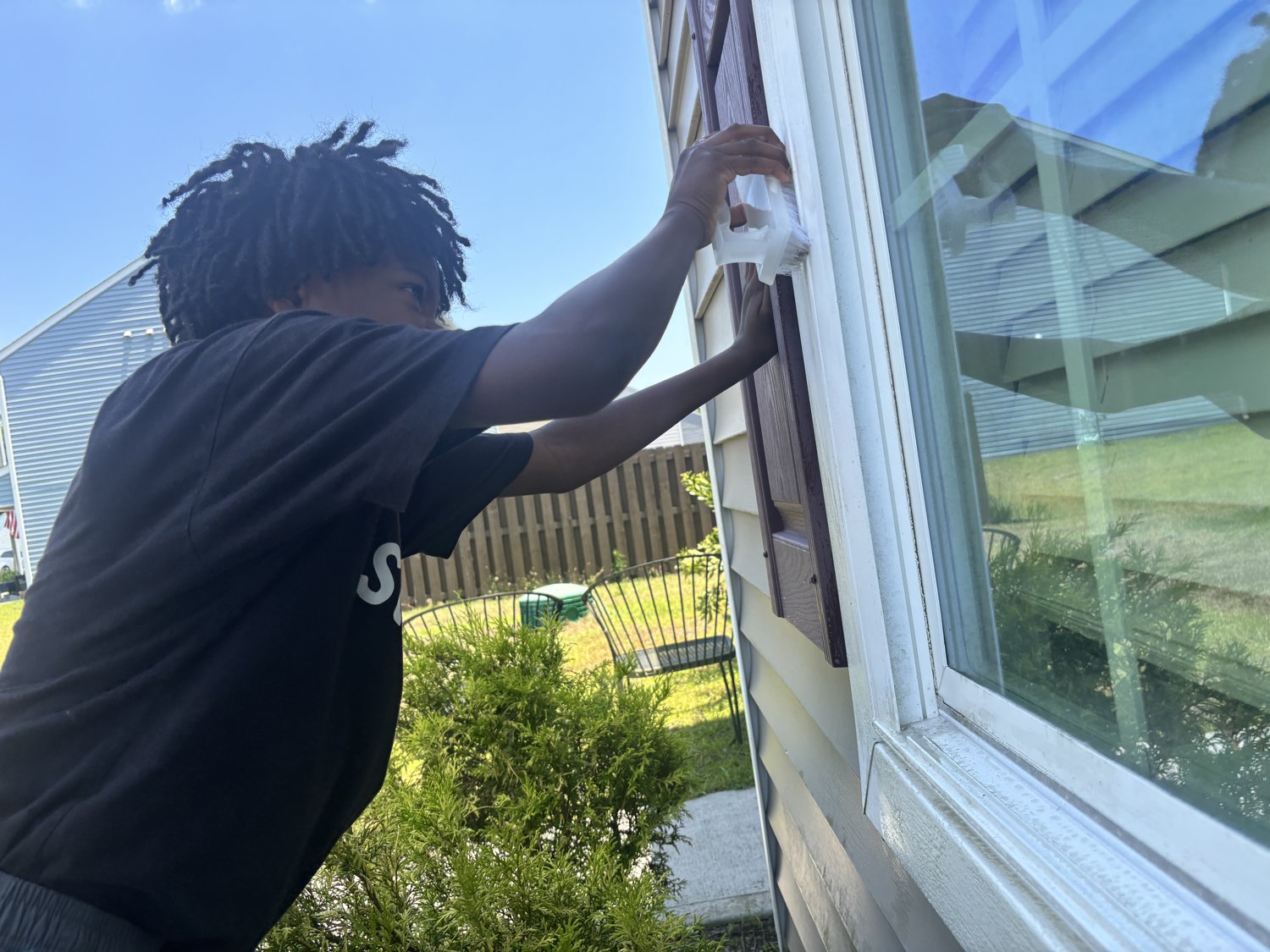 Scrubbing the window frames by hand