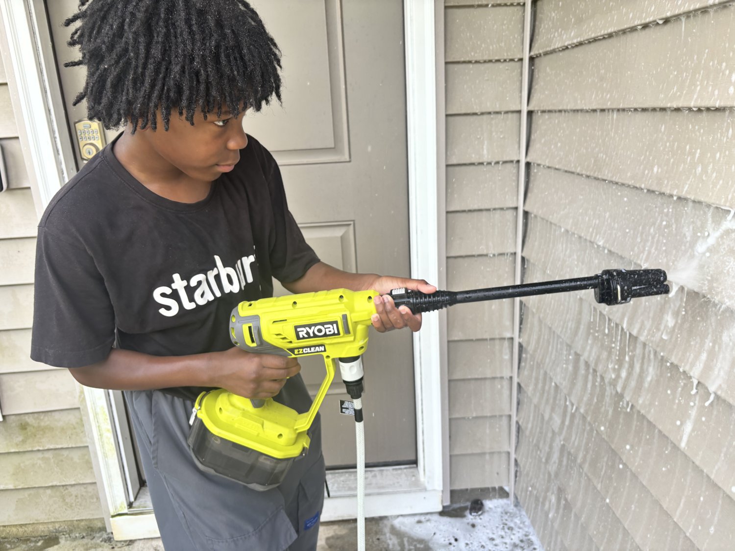 One of the OSC Services brothers working the pressure washer